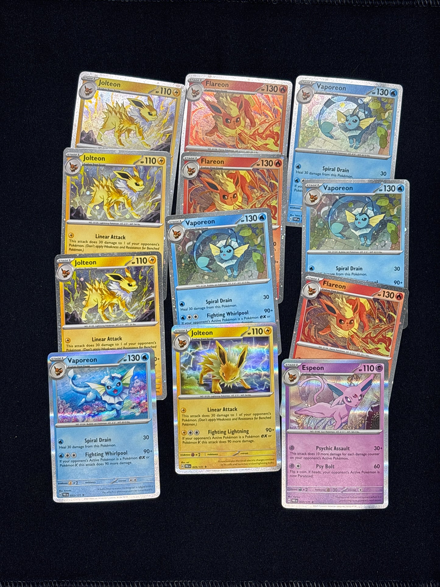 Auction Lot 33: Pokemon Prismatic Evolutions 12x Cosmo and Holo Rare Lot Conditions Vary