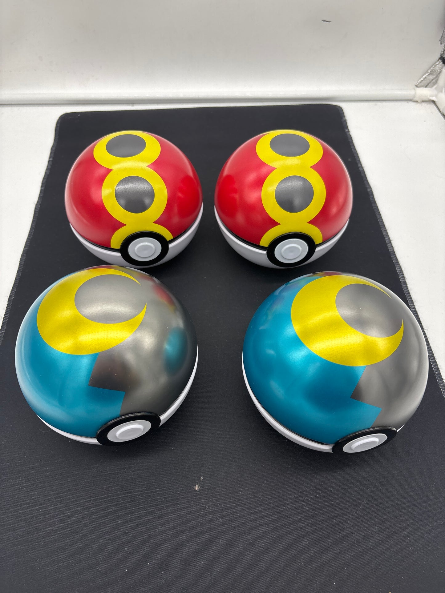 Auction Lot 23: Assorted Lot of 4 Tin Pokeballs EMPTY