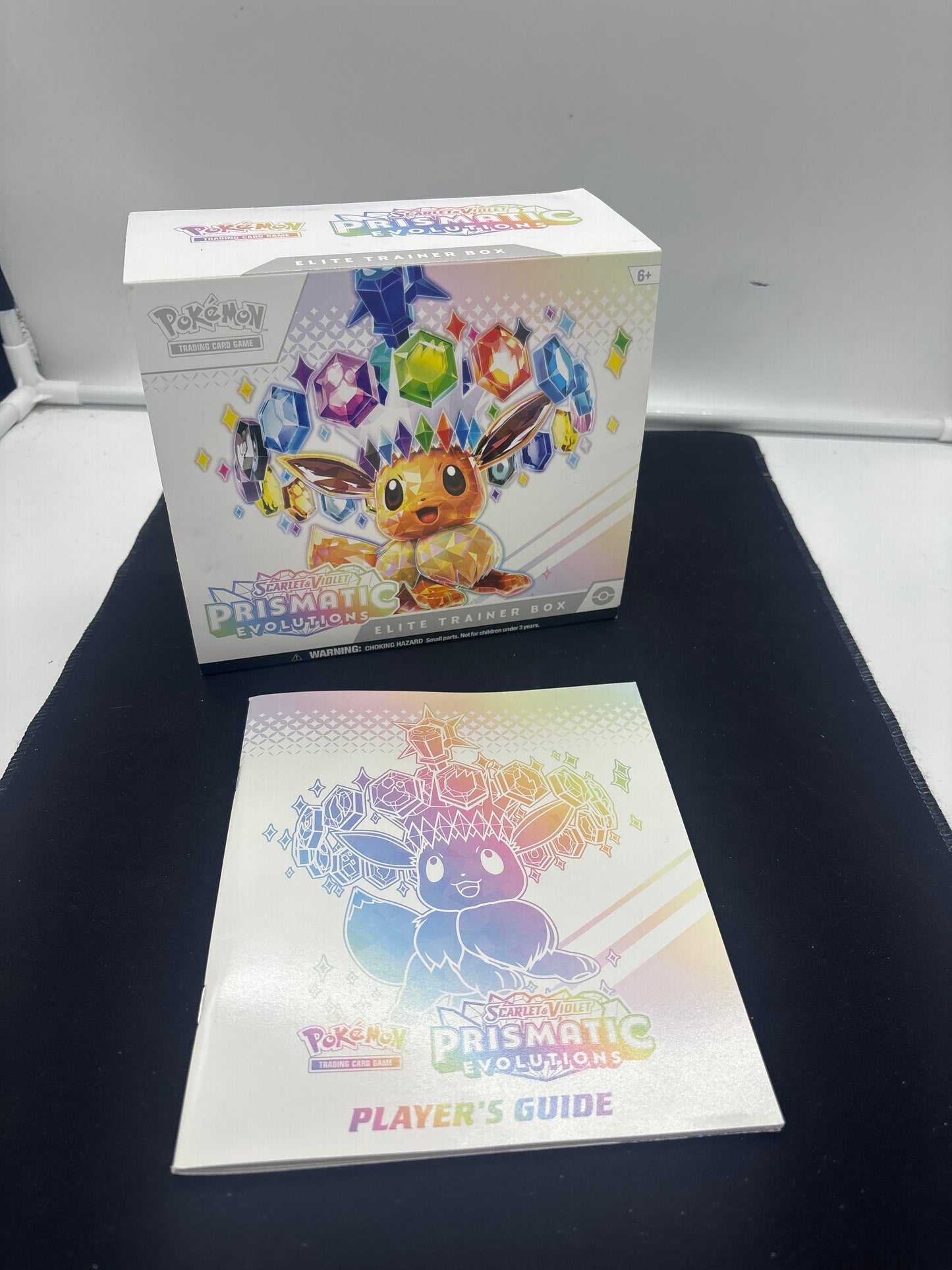Auction Lot 207: Pokemon Prismatic Evolutions Empty ETB With Player Guide