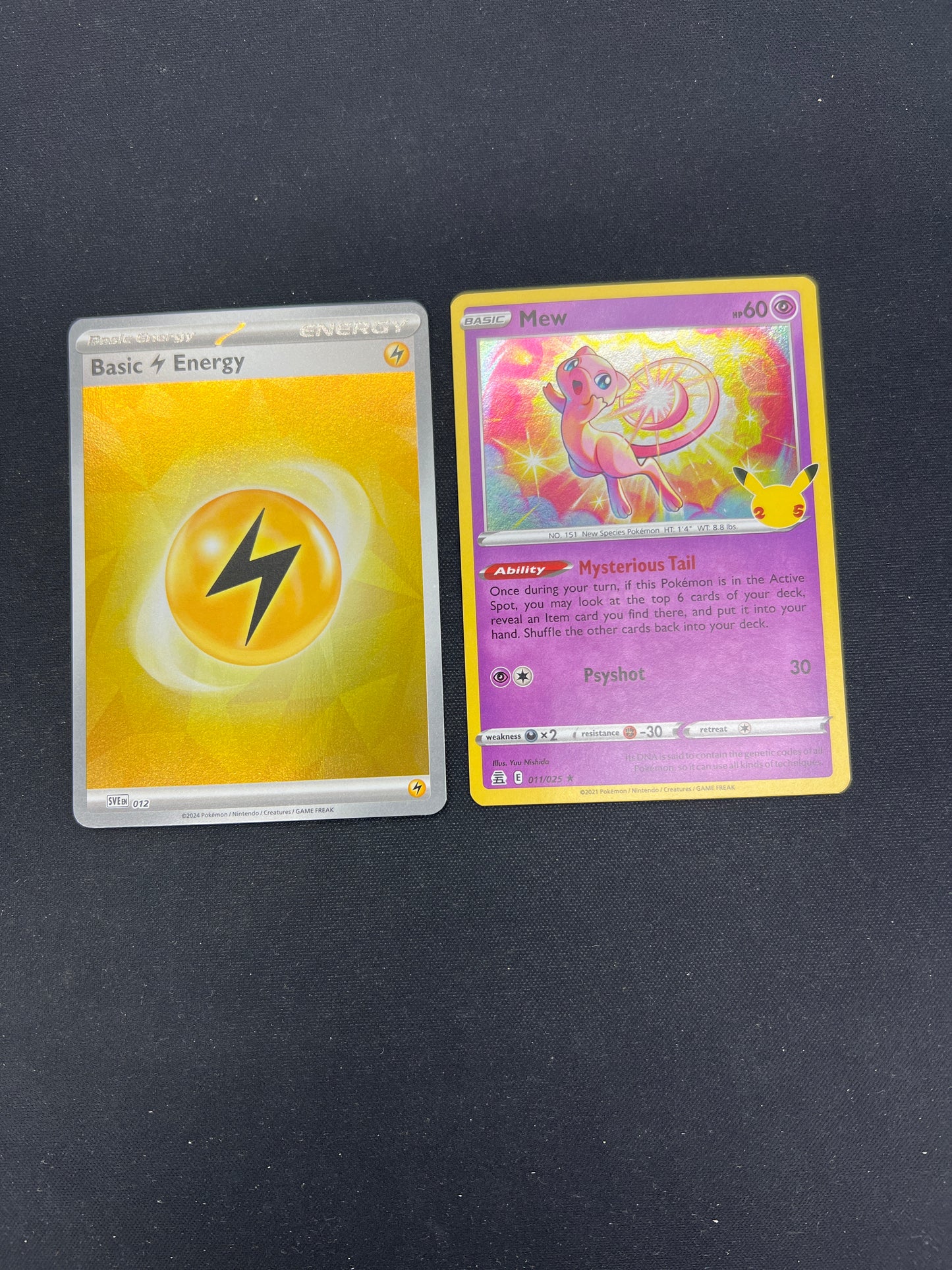Auction Lot 97: Pokemon Cards Mew Holo Celebrations and Lightning Energy Holo Conditions Vary