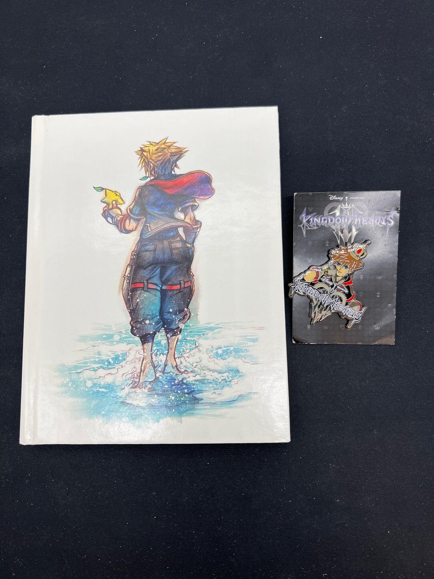 Auction Lot 266: Kingdom Hearts Assorted Keychain and Book Collectible