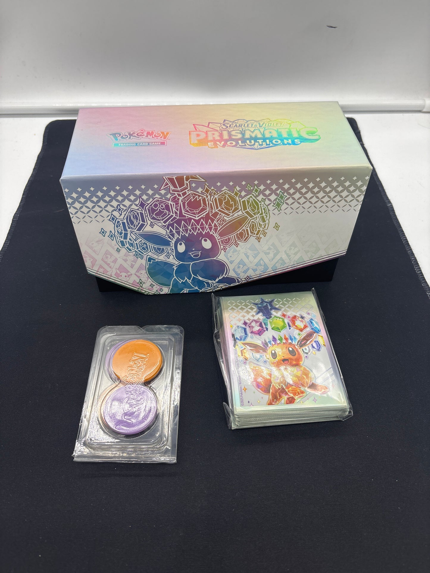 Auction Lot 271: Pokemon Prismatic Evolutions Empty ETB with Counters and Card Sleeves