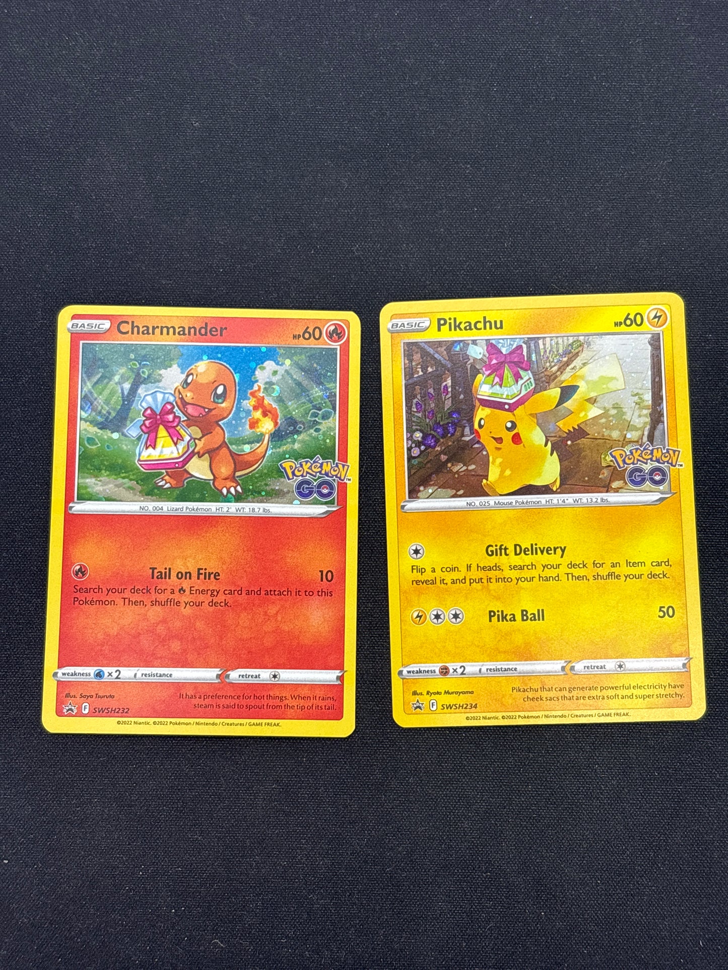 Auction Lot 57: Pokemon Cards Charmander & Pikachu Cosmo Holo Promo Stamped Pokemon GO Conditions Vary