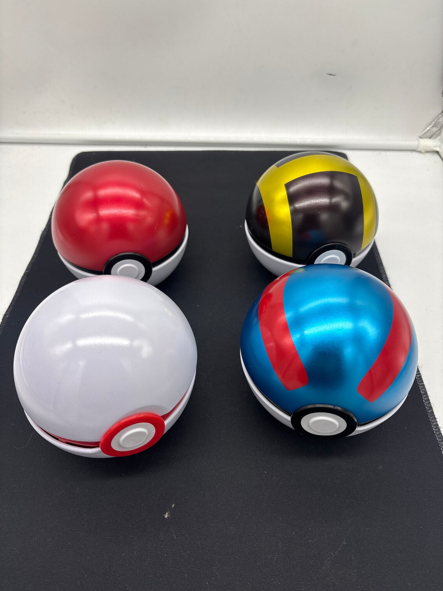 Auction Lot 22: Assorted Lot of 4 Tin Pokeballs EMPTY