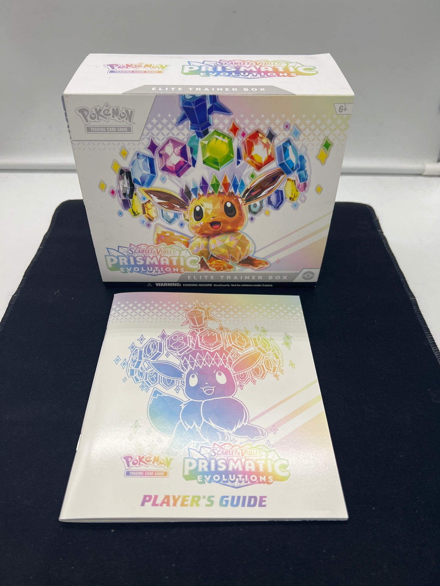 Auction Lot 200: Pokemon Prismatic Evolution Empty ETB With Player Guide