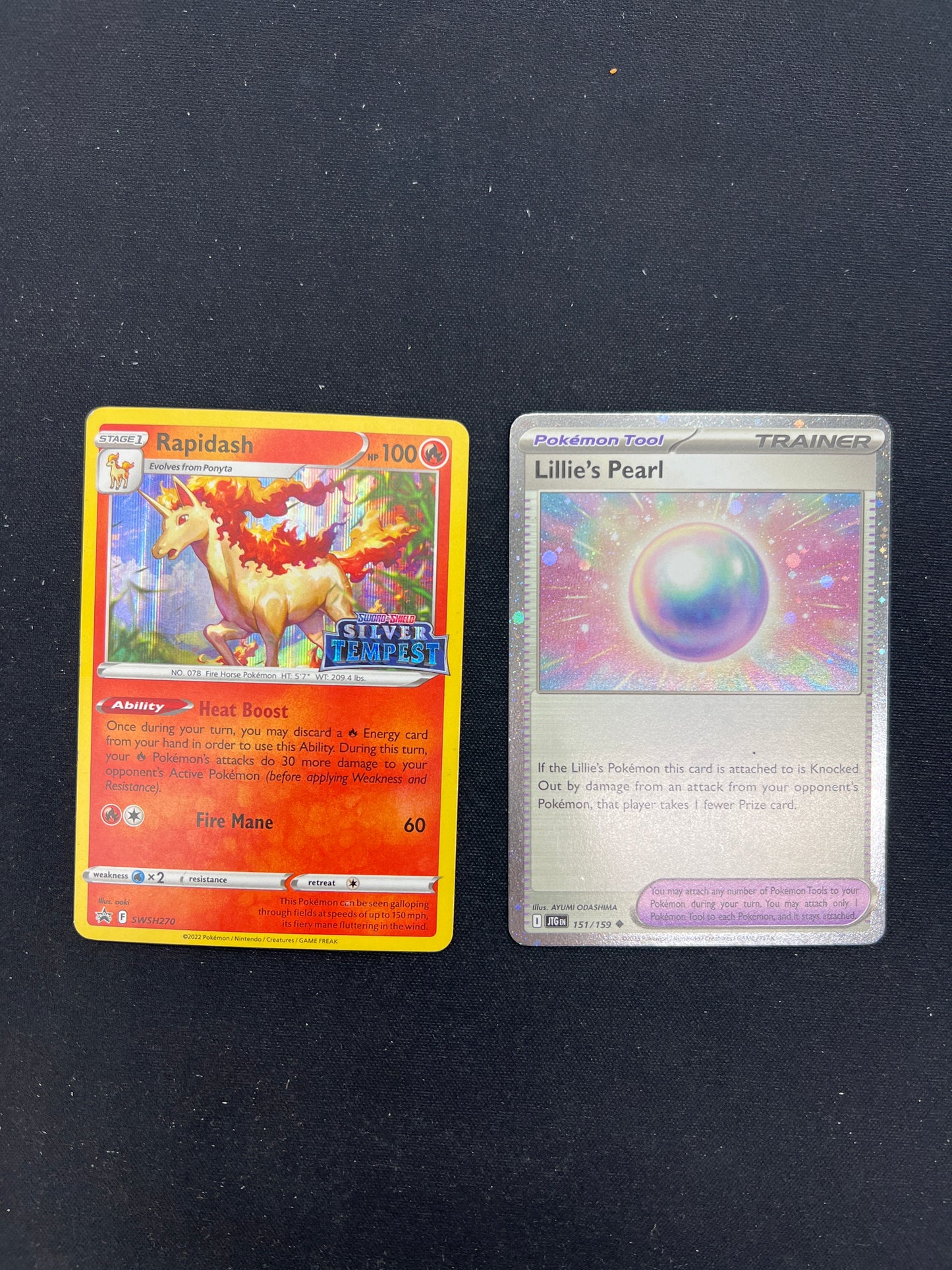 Auction Lot 121: Pokemon Cards Lot of 2 Rapidash Stamped Holo and Lillie's Pearl Cosmo Holo Conditions Vary